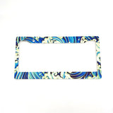 A license plate frame with a blue and white marbled design, suitable for USA and Canada plates.