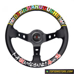 A 326 POWER HARUGUCHI branded steering wheel with a black leather grip and multicolored character decals, designed for aftermarket use.