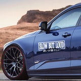 Blue car with 'SLOW BUT LOUD' decal in a desert setting