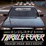 Black car with 'Thrills Seeker' branding on a racetrack