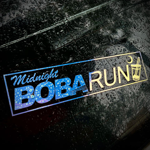 Reflective 'Midnight Boba Run' logo on a dark surface