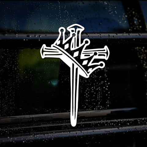 White cross with nail design on a car window