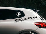 Car with decals on the side and back window, including a checkered flag design and text.