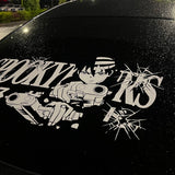Anime character decal on a car window with 'GOKU' text