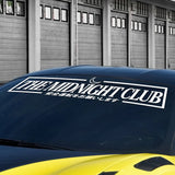 Car with 'The Midnight Club' logo on a garage background