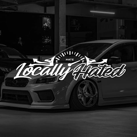 Car with 'Locally Hated' decal in a dark setting