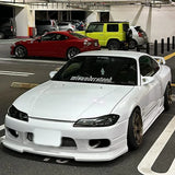 White car with 'misunderstood' decal in a parking lot with other cars.