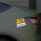 Car sticker with a warning design on a green car, featuring Roland equipment text.