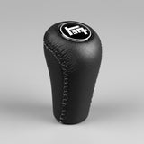 Black leather gear shift knob with a TEQ logo on a black background