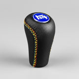 Black leather gear shift knob with colorful stitching and a blue logo on a black background