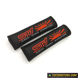 JDM STI seat belt pads with white and red Subaru Tecnica International embroidery.
