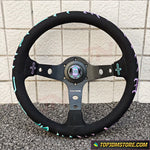 Black steering wheel with colorful accents on a tiled floor