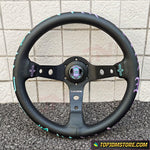 Black steering wheel with decorative elements on a tiled floor