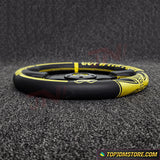 Black and yellow steering wheel cover on a textured black surface with 'TopJDMStore.com' branding.