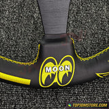 Black and yellow seat belt cover with 'MOON' logo on a textured gray background