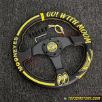 Black and yellow steering wheel with 'GO! WITH MOON' text on a textured gray background