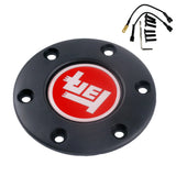 Close-up of a 70mm PCD JDM steering wheel horn button with TEQ emblem.