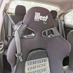 A close-up of the Racing Bucket Seat Belt Guide Holder securely holding a seat belt in place