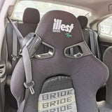 A close-up of the Racing Bucket Seat Belt Guide Holder securely holding a seat belt in place