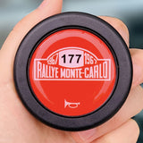 Vibrant red 1967 Rallye Monte-Carlo commemorative horn button for vintage rally car steering wheels.